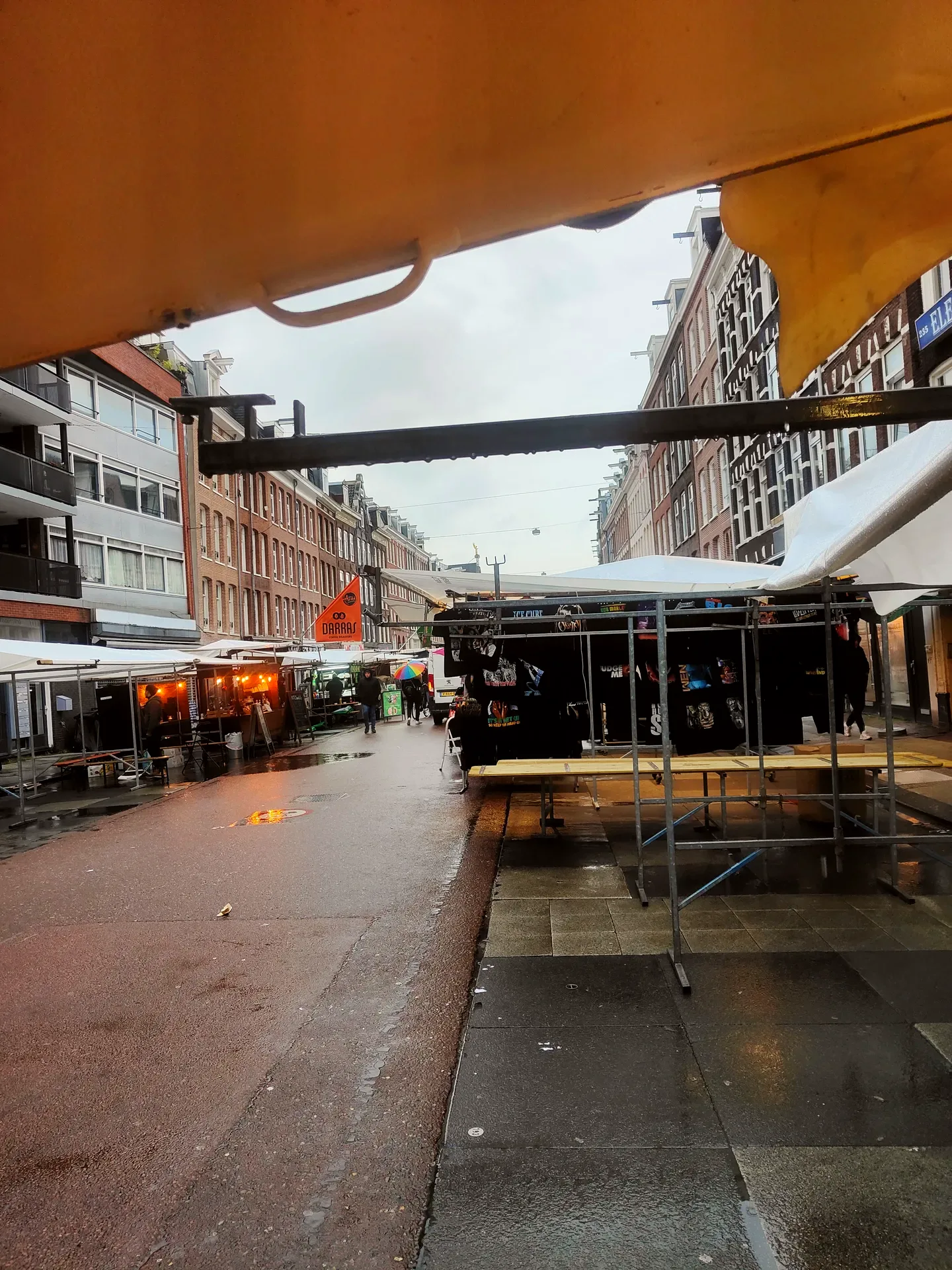the market folding its tables, the rain keeping score