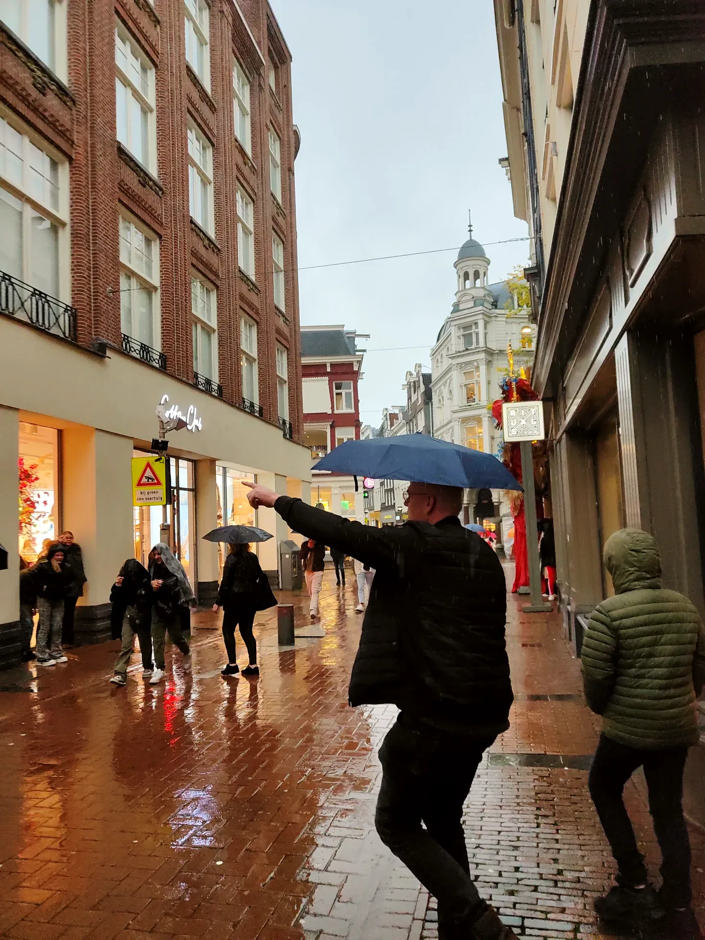 near the begijnhof, a blue umbrella against the rain and winning